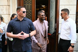 The singer was all smiles in a dusty pink suit